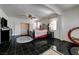 Spacious main bedroom features black tile floors, a wrought iron bed frame and access to the walk-in closet at 949 Via Stellato St, Henderson, NV 89011