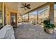 Comfortable covered patio featuring brick pavers, ceiling fans, columns, and bench seating at 949 Via Stellato St, Henderson, NV 89011