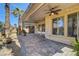 Inviting covered patio featuring brick pavers, ceiling fans, columns, and bench seating at 949 Via Stellato St, Henderson, NV 89011