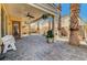 Covered patio with brick pavers, ceiling fans, columns and a bench, perfect for outdoor relaxation at 949 Via Stellato St, Henderson, NV 89011