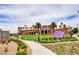 Inviting community recreation center with lush landscaping, palm trees, and clear blue skies at 949 Via Stellato St, Henderson, NV 89011