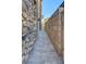 Home's side yard featuring a stone and brick walkway and partial view of the house at 949 Via Stellato St, Henderson, NV 89011