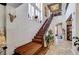 Grand staircase featuring hardwood steps, iron railings, and a chandelier above at 949 Via Stellato St, Henderson, NV 89011
