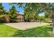 Sandy outdoor volleyball court surrounded by green trees and grass at 949 Via Stellato St, Henderson, NV 89011