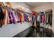 Large walk in closet with black tile floors and ample clothing storage on multiple racks at 949 Via Stellato St, Henderson, NV 89011