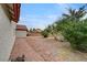 Wide shot of backyard featuring mature trees, and partial stone patio at 9529 Shallow Brook Cir, Las Vegas, NV 89117