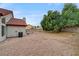 Backyard featuring rock landscaping, block wall, and mature tree at 9529 Shallow Brook Cir, Las Vegas, NV 89117