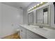Bathroom featuring double sinks with white cabinets and modern fixtures at 9529 Shallow Brook Cir, Las Vegas, NV 89117