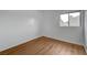 Bedroom with wood flooring and view of neighborhood through the window at 9529 Shallow Brook Cir, Las Vegas, NV 89117