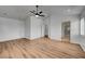 Spacious bedroom with wood flooring, ceiling fan, and ensuite at 9529 Shallow Brook Cir, Las Vegas, NV 89117