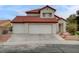 Two-story home featuring a red tile roof, a three-car garage, and low-maintenance landscaping at 9529 Shallow Brook Cir, Las Vegas, NV 89117