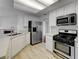 Contemporary kitchen featuring stainless steel appliances and white cabinets at 9529 Shallow Brook Cir, Las Vegas, NV 89117