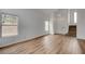 View of the open living room with wood-look floors, staircase, and lots of natural light at 9529 Shallow Brook Cir, Las Vegas, NV 89117