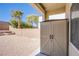 Storage shed and brick-paver patio with views of the backyard that is enclosed by a brick wall and gravel ground cover at 9617 Fast Elk St, Las Vegas, NV 89143