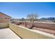 Balcony view of the backyard featuring desert landscaping, palm trees, and neighborhood views at 9617 Fast Elk St, Las Vegas, NV 89143