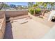 Large backyard area is enclosed by a brick wall, gravel and brick-paver ground cover and trees, awaiting your creativity at 9617 Fast Elk St, Las Vegas, NV 89143