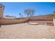 Large backyard area is enclosed by a brick wall, gravel and brick-paver ground cover and trees, awaiting your creativity at 9617 Fast Elk St, Las Vegas, NV 89143
