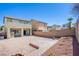 View of backyard with brick wall enclosure, brick paved patio and gravel ground cover at 9617 Fast Elk St, Las Vegas, NV 89143