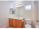 Bathroom vanity features wood cabinets and a full shower at 9617 Fast Elk St, Las Vegas, NV 89143