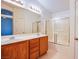 Bathroom boasts double sinks, vanity, and a sliding glass door shower/tub combination at 9617 Fast Elk St, Las Vegas, NV 89143