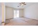 Large, light-filled primary bedroom with ceiling fan and sliding glass door to balcony at 9617 Fast Elk St, Las Vegas, NV 89143