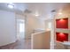 Bright hallway with neutral walls, carpet flooring, and unique architectural details at 9617 Fast Elk St, Las Vegas, NV 89143