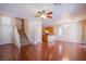 An open concept with hardwood floors combines the living room, stairs, and kitchen at 9617 Fast Elk St, Las Vegas, NV 89143