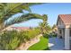 Lush backyard with palm trees, artificial turf, and a view of the mountains at 9920 Netherton Dr, Las Vegas, NV 89134