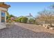 Serene backyard showcasing a well-maintained landscape and a charming home exterior at 9920 Netherton Dr, Las Vegas, NV 89134