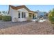 Beautiful backyard with desert landscaping, covered patio, and outdoor seating area at 9920 Netherton Dr, Las Vegas, NV 89134