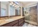Bathroom with granite countertops, double sinks and a glass-enclosed shower at 9920 Netherton Dr, Las Vegas, NV 89134