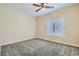 Bedroom with neutral carpeting, fan, and shuttered windows at 9920 Netherton Dr, Las Vegas, NV 89134