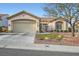 Inviting single-story home with a two-car garage and well-maintained landscaping at 9920 Netherton Dr, Las Vegas, NV 89134