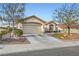 Charming single-story home featuring a two-car garage and desert landscaping at 9920 Netherton Dr, Las Vegas, NV 89134