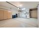 Spacious garage with ample storage cabinets and a convenient laundry area at 9920 Netherton Dr, Las Vegas, NV 89134