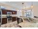 Kitchen area showcasing stainless steel appliances, granite countertops, and dark cabinetry at 9920 Netherton Dr, Las Vegas, NV 89134