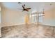 Spacious living area featuring tile flooring, a ceiling fan, and natural light at 9920 Netherton Dr, Las Vegas, NV 89134