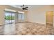 Bright living room with sliding glass doors to the outside, neutral paint, and tile flooring at 9920 Netherton Dr, Las Vegas, NV 89134