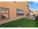 Backyard with putting green, outdoor seating, and exterior view of the house at 10133 Longoria St, Las Vegas, NV 89178