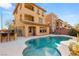 Backyard with a pool, lounge chairs, outdoor bar area, and nice landscaping at 10133 Longoria St, Las Vegas, NV 89178