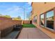 Turf backyard with outdoor seating and views of the home's exterior windows at 10133 Longoria St, Las Vegas, NV 89178