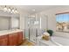 Spacious bathroom with soaking tub, glass shower and large vanity at 10133 Longoria St, Las Vegas, NV 89178