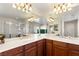 Large vanity area with dual sinks and ample lighting in bathroom at 10133 Longoria St, Las Vegas, NV 89178