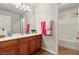 Bright bathroom featuring a vanity with a white countertop and a shower-tub combo at 10133 Longoria St, Las Vegas, NV 89178