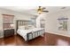 Comfortable bedroom with hardwood floors, a ceiling fan, and large windows at 10133 Longoria St, Las Vegas, NV 89178