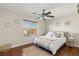 Bedroom with wood floor, natural light from the window and ceiling fan at 10133 Longoria St, Las Vegas, NV 89178