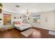 Bedroom with wood floor, natural light from the windows, ceiling fan, and decor at 10133 Longoria St, Las Vegas, NV 89178