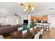 Open-concept dining area connected to the living room and kitchen, featuring a modern chandelier at 10133 Longoria St, Las Vegas, NV 89178