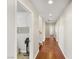 Long hallway with wood floors, white trim, recessed lights, and a peek into the laundry room at 10133 Longoria St, Las Vegas, NV 89178