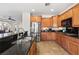 Charming kitchen with stainless steel appliances, wood cabinets, and tile floor at 10133 Longoria St, Las Vegas, NV 89178